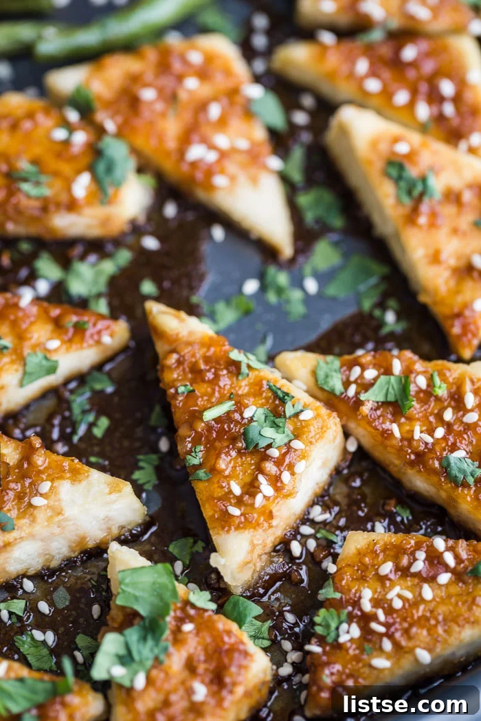 Artfully arranged sesame-crusted tofu triangles showcasing a delicious texture