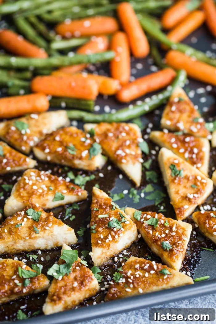 A close-up shot of a serving of sheet pan tofu and veggies, garnished with fresh cilantro