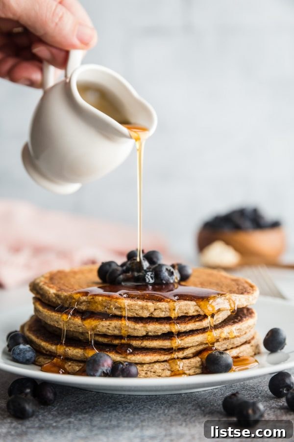 Delicious stack of vegan protein pancakes with fresh berries.