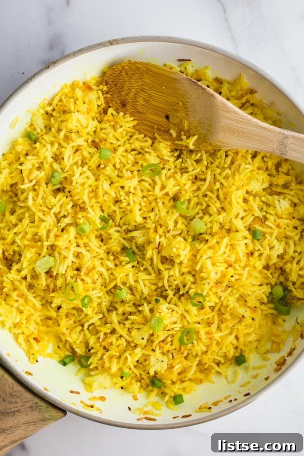 Close-up of golden Turmeric Lemon Rice in a bowl, showing fluffy texture and lemon zest