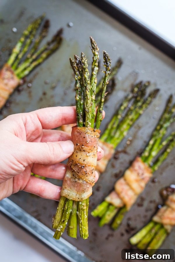 Cooked bacon-wrapped asparagus, glistening and ready to eat