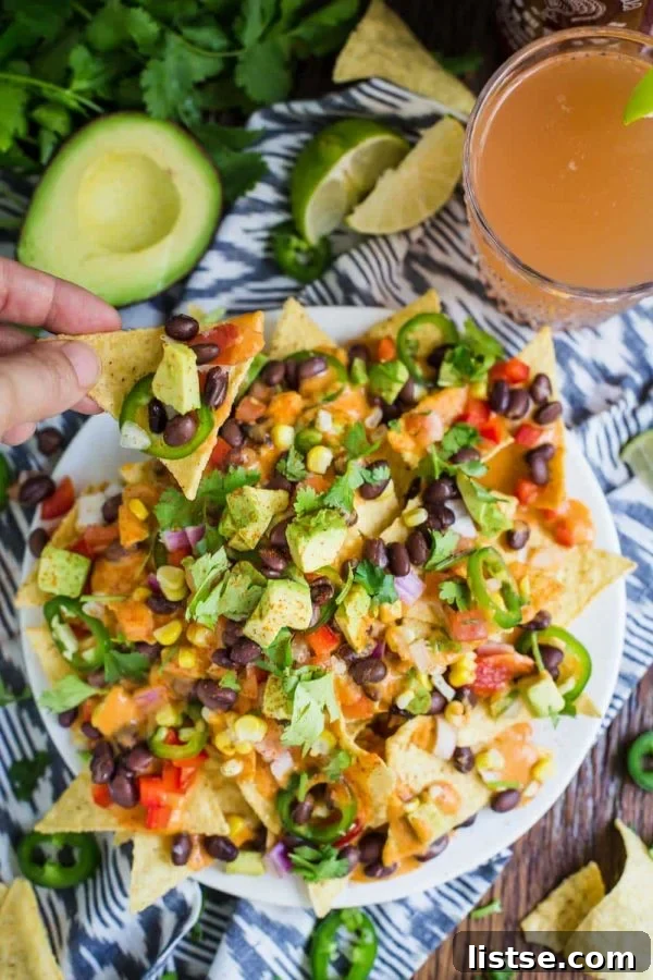 Platter of epic loaded vegan nachos with various toppings