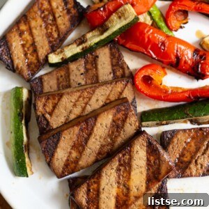 Grilled tofu served with grilled peppers, showcasing a complete and appetizing plant-based meal.