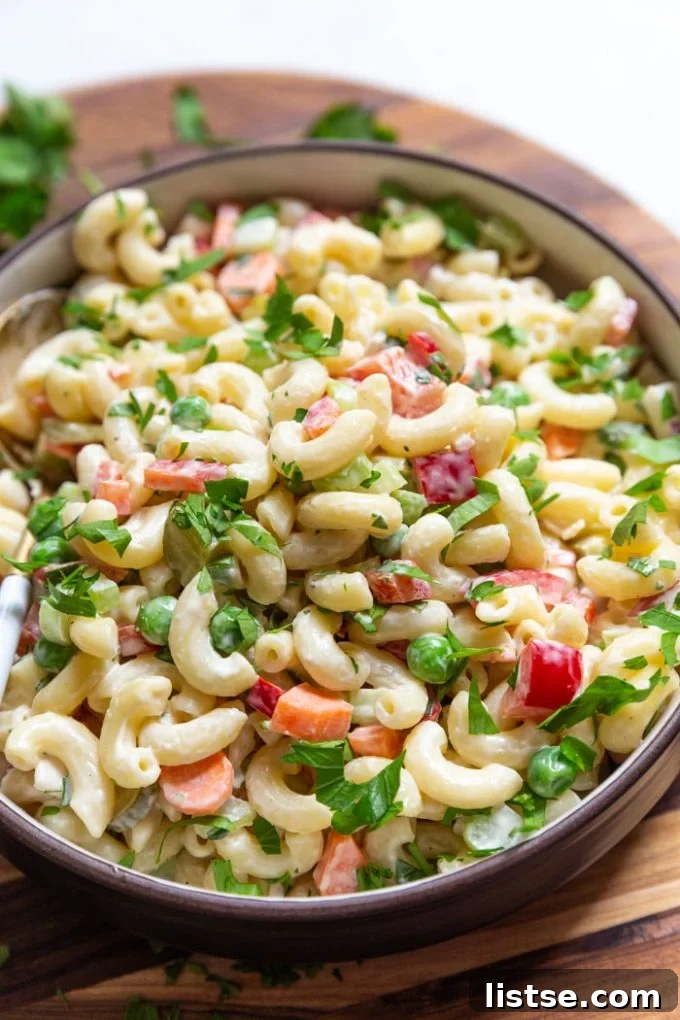 Creamy Plant-Based Macaroni Bliss 2 Delicious vegan macaroni salad in a large serving bowl, garnished with fresh herbs.