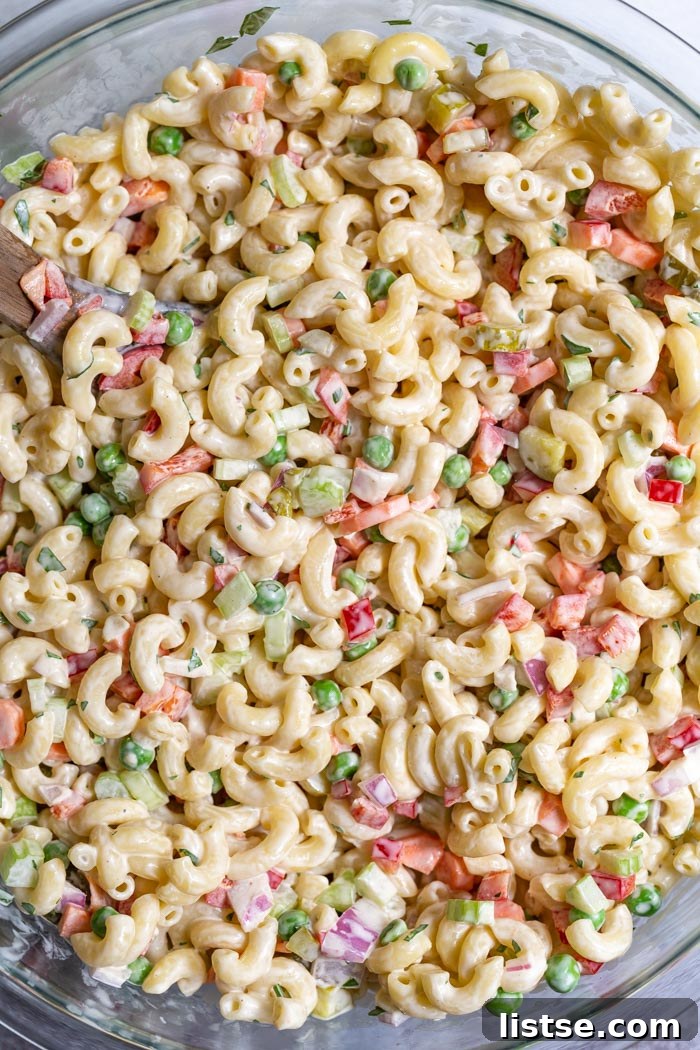 Creamy Plant-Based Macaroni Bliss 3 Close-up of the best vegan macaroni salad with colorful chopped vegetables visible.