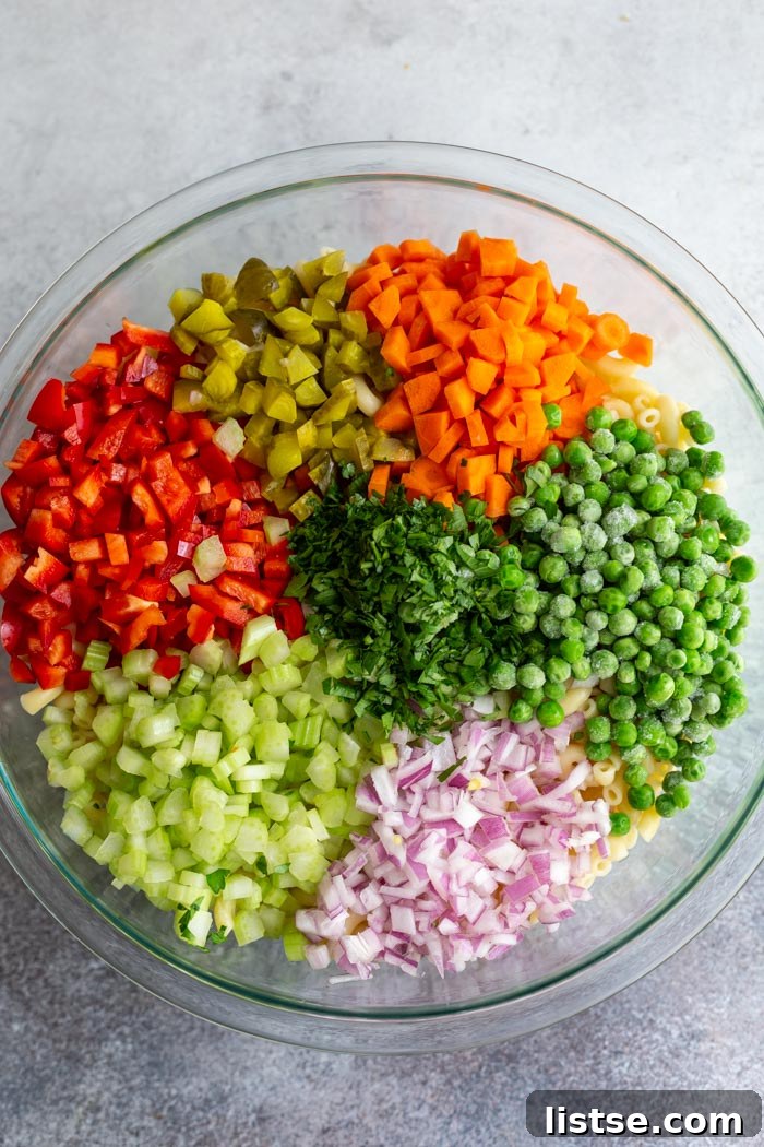 Creamy Plant-Based Macaroni Bliss 4 A serving of creamy vegan macaroni salad with a fork, ready to be enjoyed.