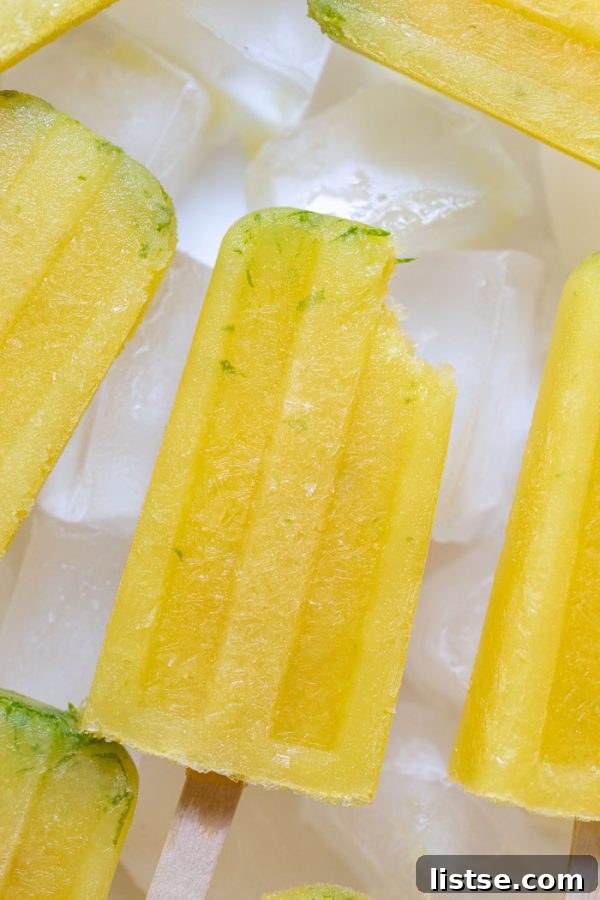 Hand holding a frozen margarita popsicle garnished with salt