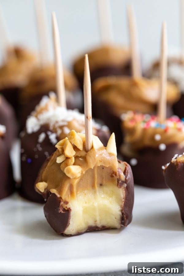 Delicious chocolate covered banana bites, some with peanut butter, ready to be frozen for a refreshing summer treat.