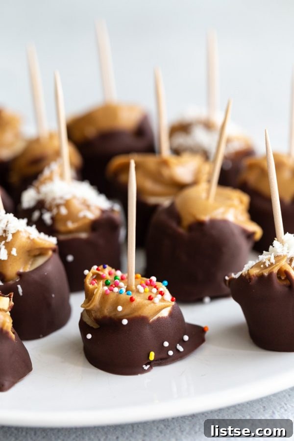 Close-up of peanut butter topped banana slices, ready for freezing before being dipped in chocolate.