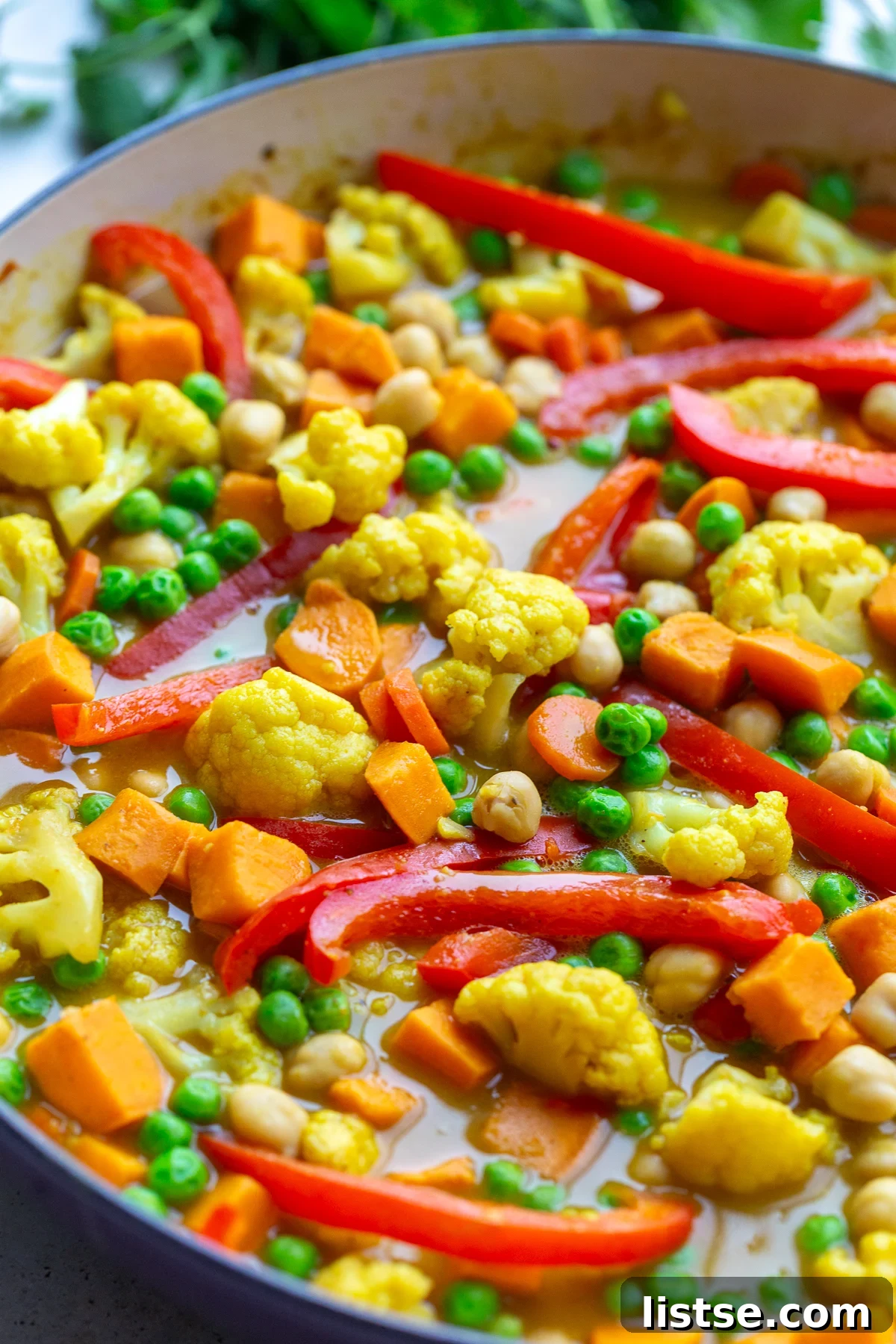 Golden Vegan Chickpea and Sweet Potato Coconut Curry 9 A large skillet filled with the finished chickpea and sweet potato curry, rich and creamy, ready to be served family-style.