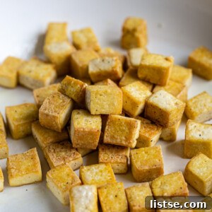 Crispy pan-fried tofu in a skillet.