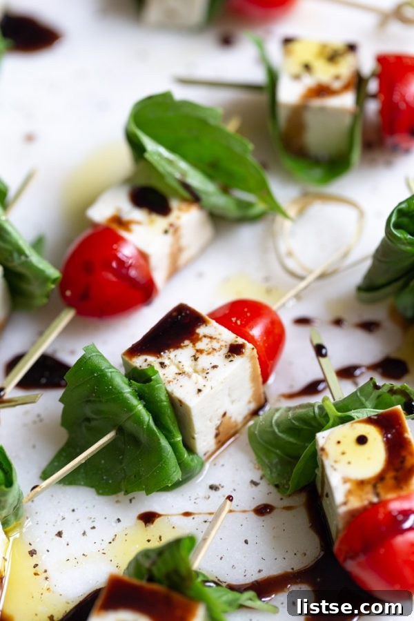 Platter of Tofu Caprese Skewers with a balsamic glaze drizzle