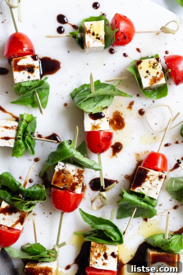 Beautifully arranged Caprese skewers with tofu, basil, and tomatoes