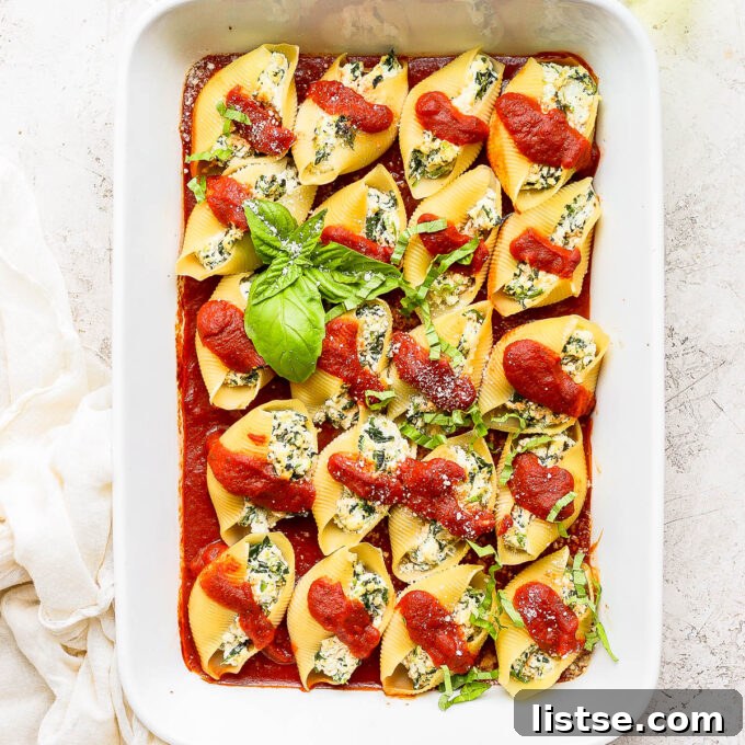 Creamy Vegan Stuffed Shells 2 Delicious vegan stuffed shells covered in rich marinara sauce and garnished with fresh basil leaves.