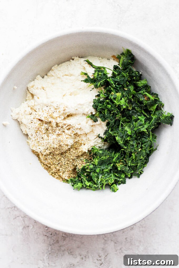 Creamy Vegan Stuffed Shells 4 Adding vegan ricotta and spinach to a large mixing bowl.