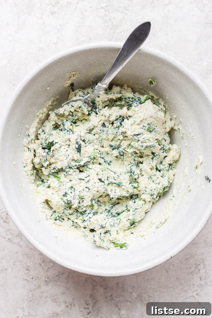Creamy Vegan Stuffed Shells 5 Stirring the vegan ricotta and spinach mixture until well combined for the filling.