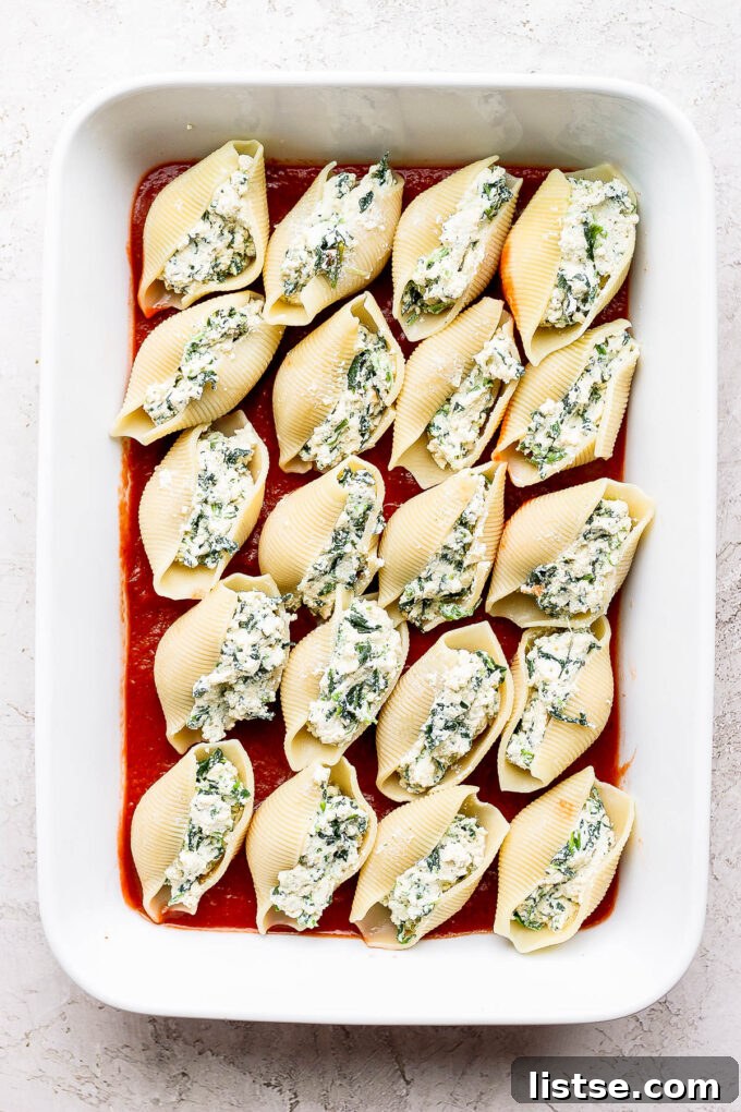 Creamy Vegan Stuffed Shells 6 Jumbo pasta shells neatly stuffed with vegan ricotta and arranged in a baking dish.