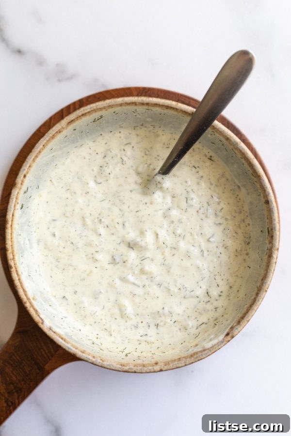 Zesty Vegan Tartar 2 Delicious homemade vegan tartar sauce in a small bowl with a spoon