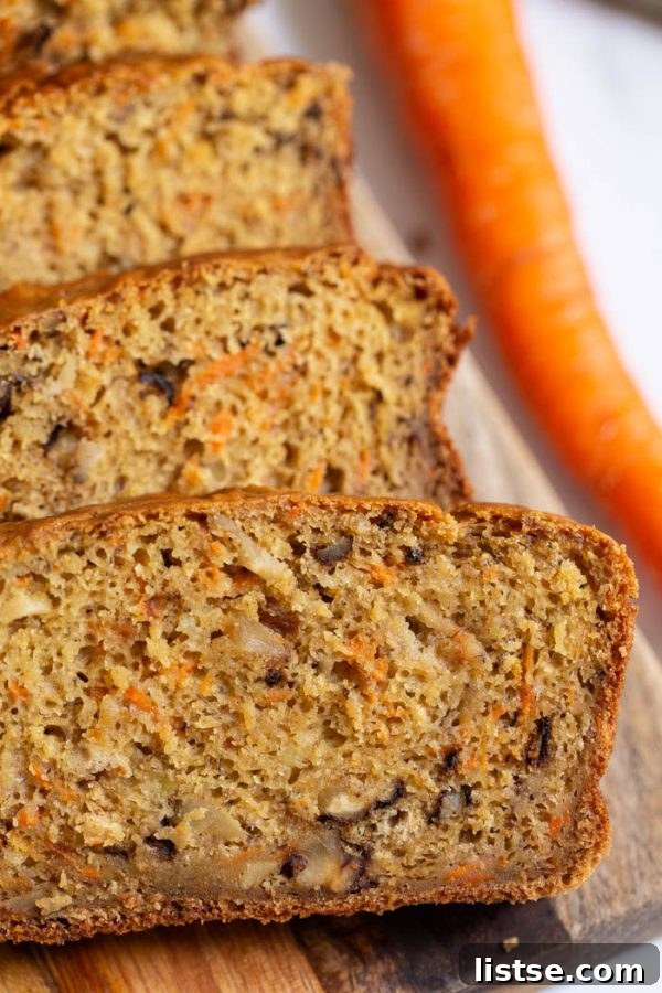 Vegan Carrot Cake Bread 5 A freshly baked slice of Vegan Carrot Bread, showing its moist and tender crumb and hints of carrot and nuts.