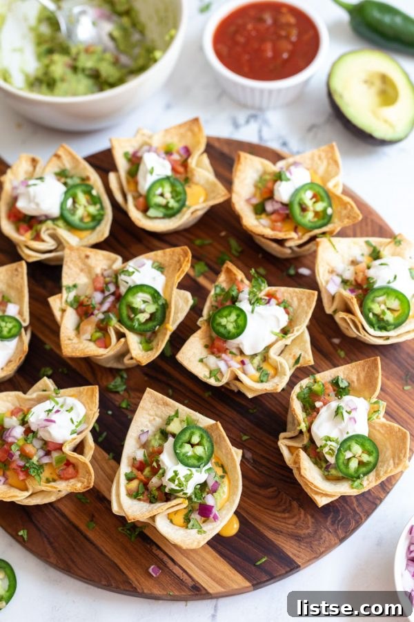 Assortment of vibrant vegan taco cups with various toppings