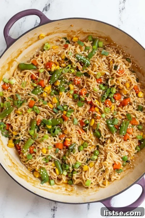 Close-up of cooked ramen noodles with stir-fried vegetables and green onions, showcasing the texture and fresh ingredients.
