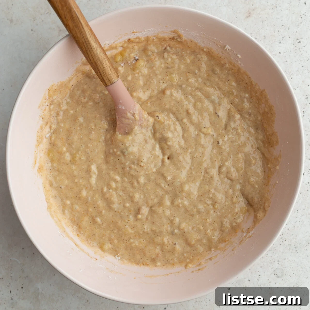 A large bowl filled with smooth, pale yellow donut batter, ready to be piped.