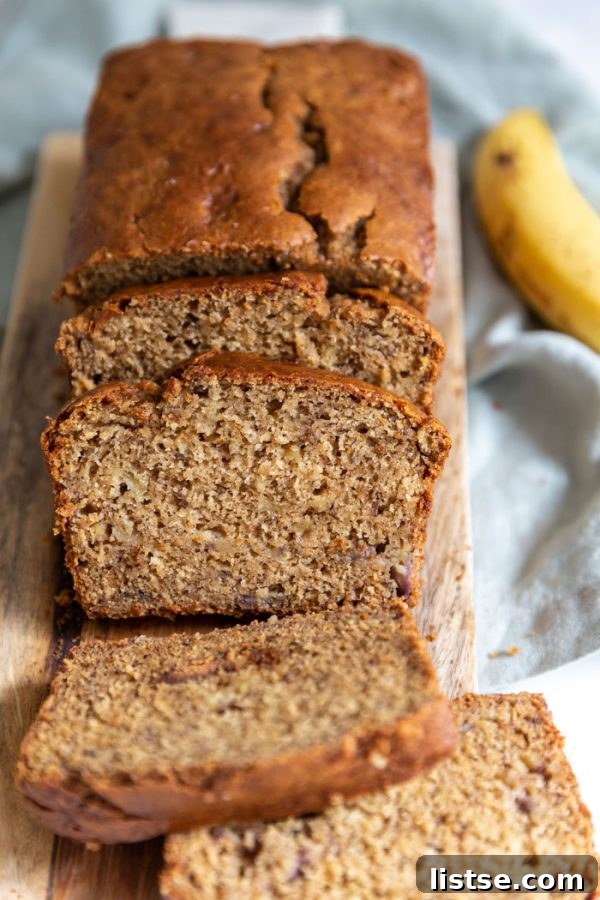 Plant-Powered Banana Loaf 2 Sliced Vegan Banana Bread on a wooden board, ready to be served.