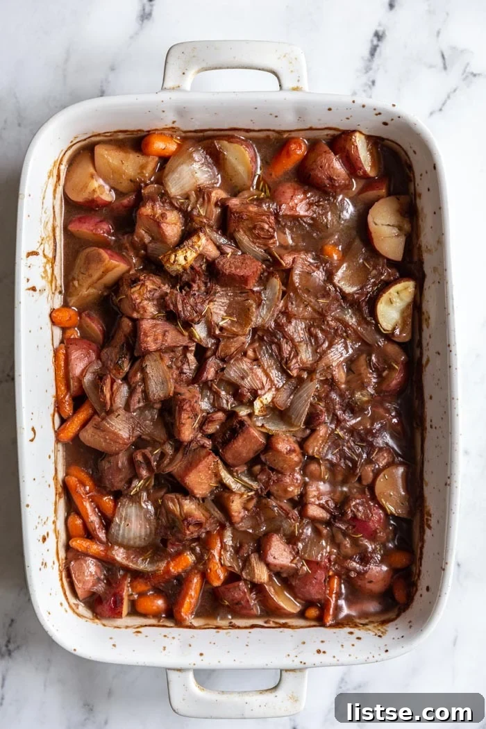 Savory Jackfruit Braise 5 Unbaked jackfruit pot roast with raw vegetables in a baking dish.
