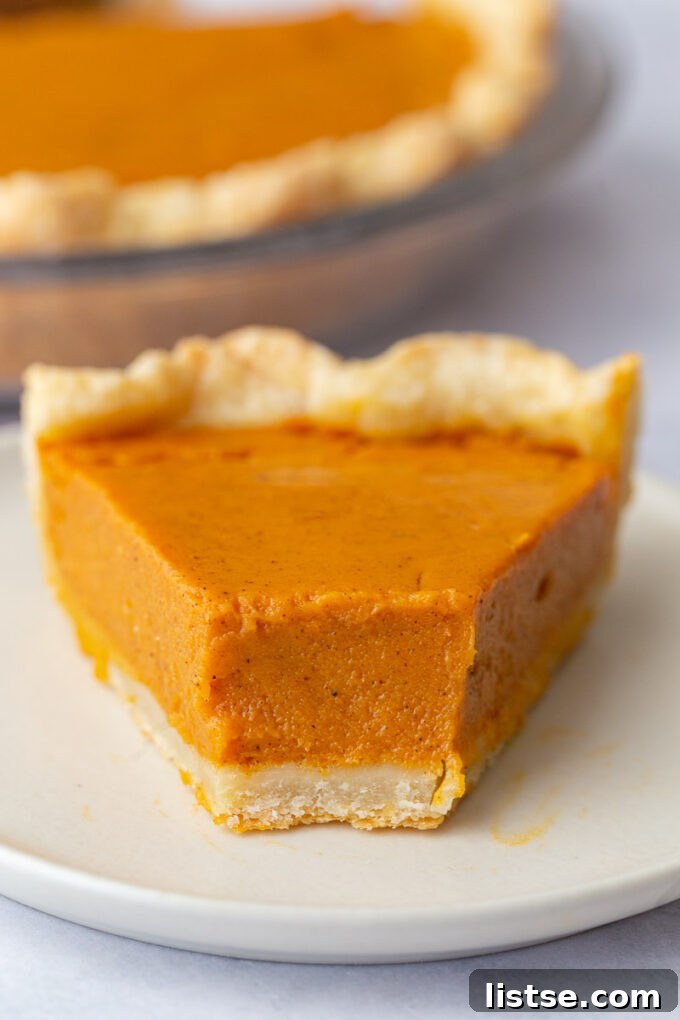 Golden Sweet Potato Heaven 2 slice of sweet potato pie with a bite taken out and the rest of the pie in the background