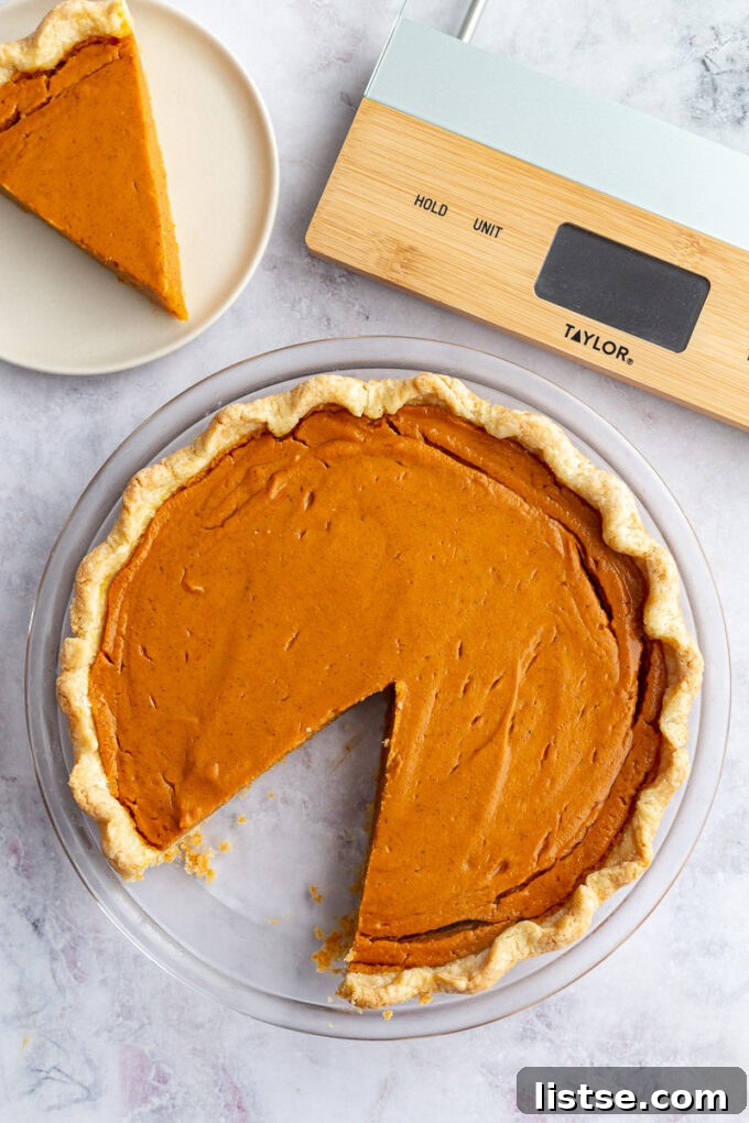 Golden Sweet Potato Heaven 3 sweet potato pie with a slice cut out and a Taylor kitchen scale in the corner of the shot