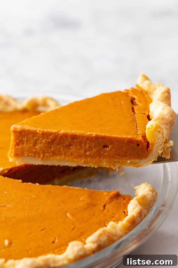 Golden Sweet Potato Heaven 5 slice of sweet potato pie being lifted from the pan