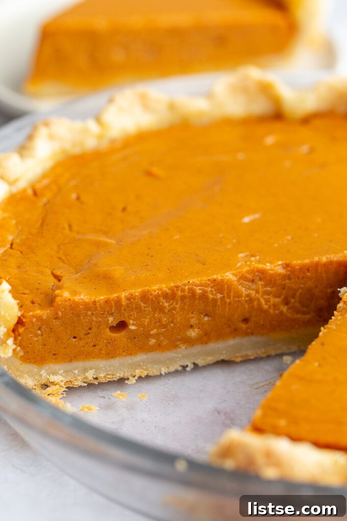 Golden Sweet Potato Heaven 6 up close shot of sweet potato pie with a slice taken out