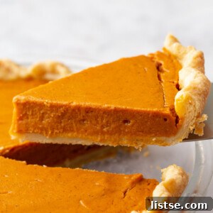 Golden Sweet Potato Heaven 8 slice of sweet potato pie being lifted from the pan
