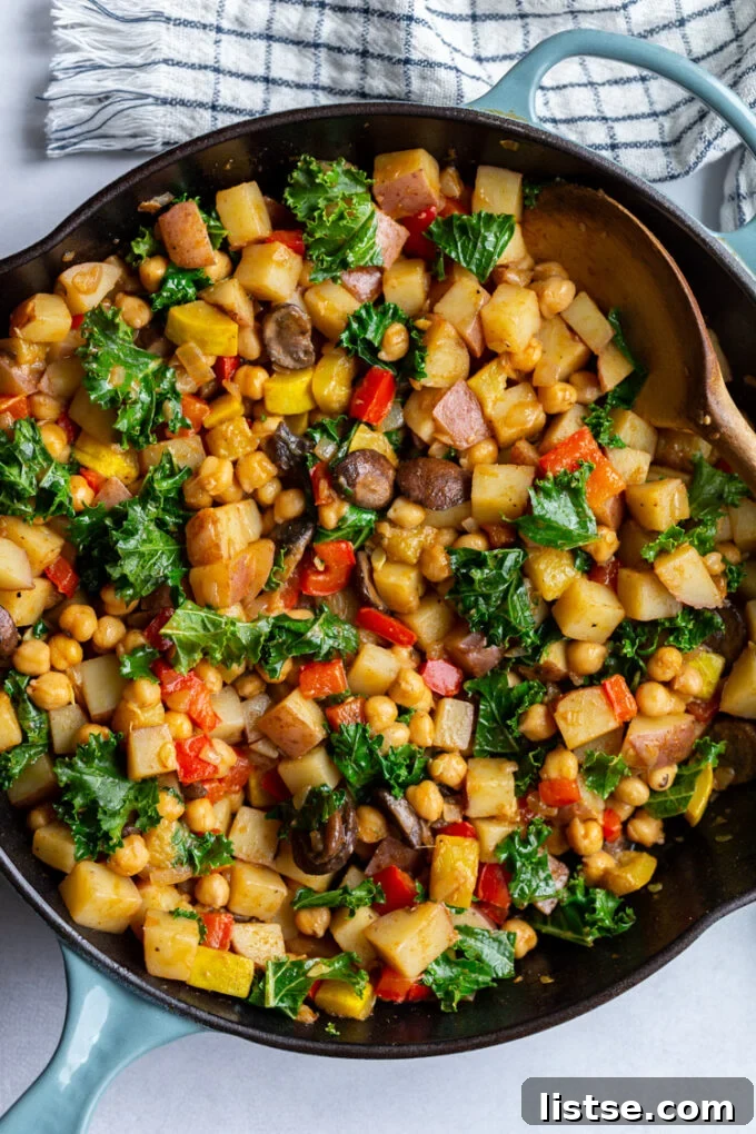 Vibrant vegan hash bursting with colorful vegetables in a large skillet