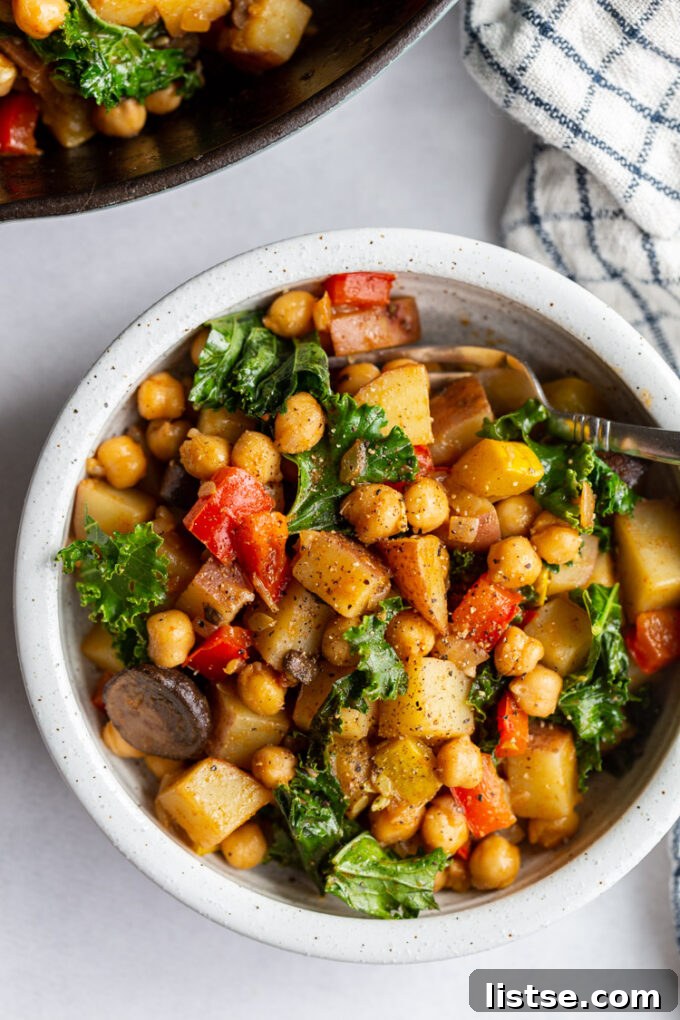 Single serving of vegan hash in a small white bowl, garnished with fresh herbs