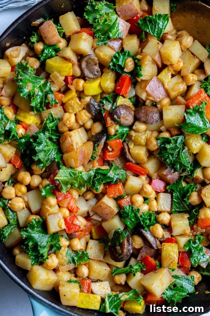 Close-up of vegan hash with potatoes, chickpeas, and various colorful vegetables
