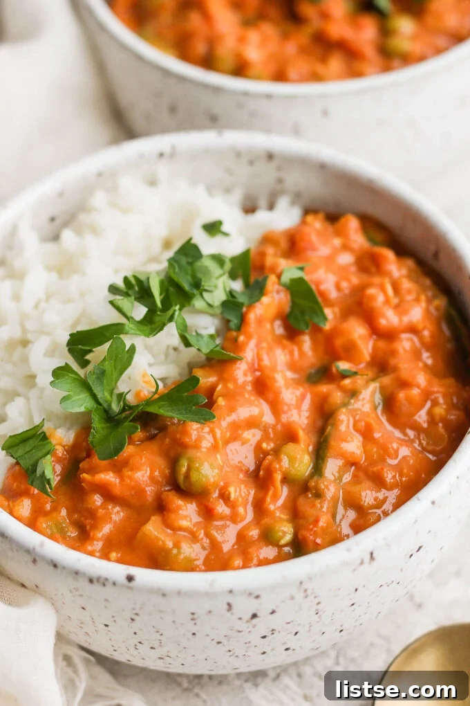 Creamy lentil curry with fresh cilantro served in a bowl over rice.