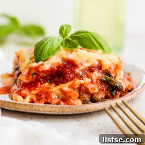 Ultimate Vegan Lasagna 8 Vegan lasagna on a plate garnished with basil.