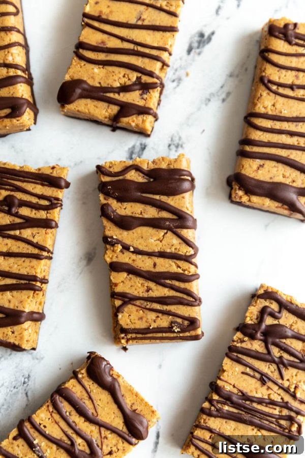 Top-down view of a batch of homemade vegan protein bars covered in a rich chocolate layer, showcasing their delicious appeal as a healthy snack.