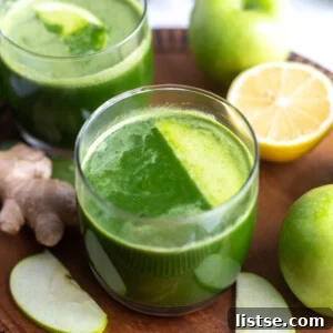 Freshly made Apple Green Juice in a glass with apples