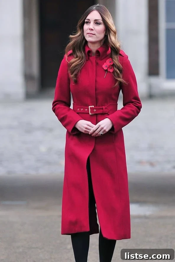 Kate Middleton in a striking long red coat, exuding warmth and style.