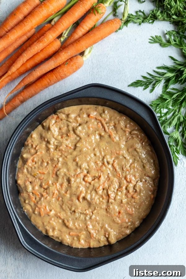 Close-up shot of vegan carrot cake batter, showing shredded carrots and nuts