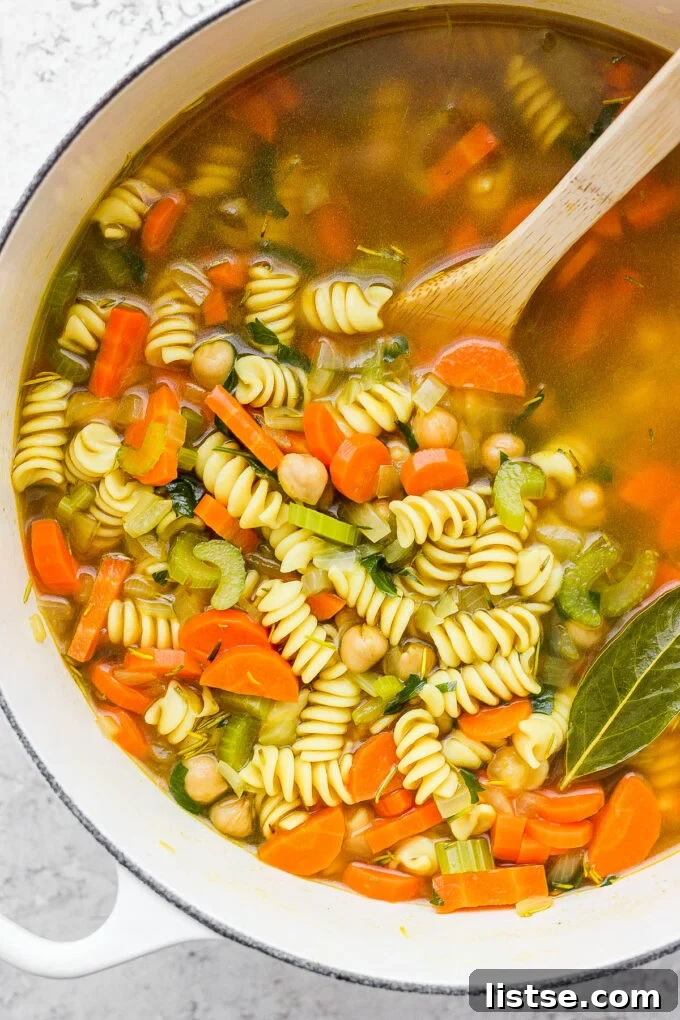 Golden Chickpea Noodle Hug 2 Hearty chickpea noodle soup simmering in a large pot on the stovetop.