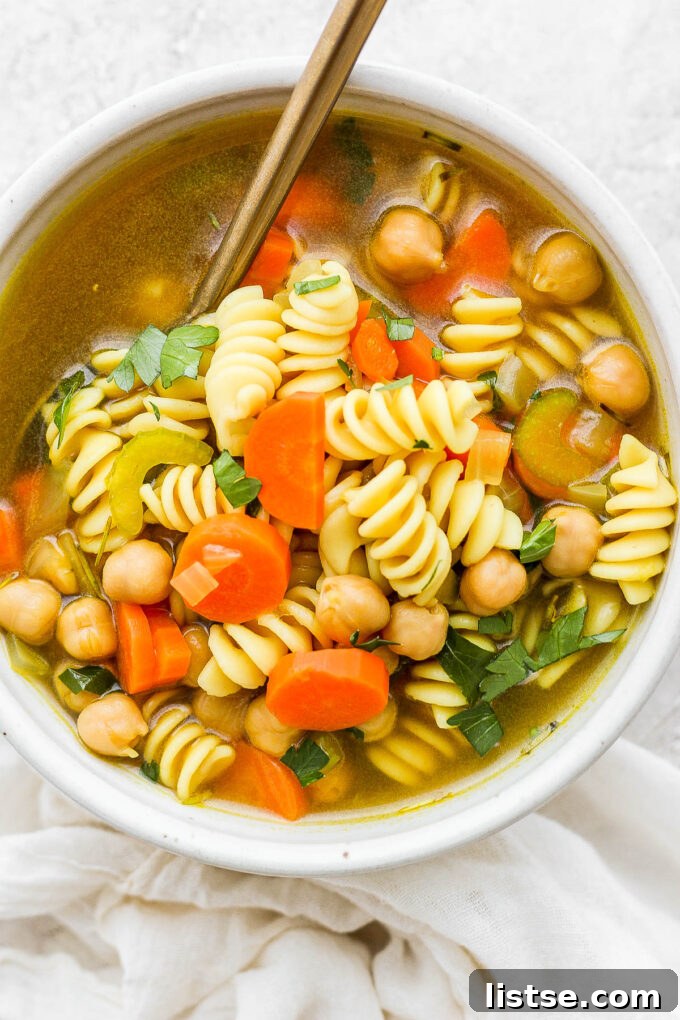 Golden Chickpea Noodle Hug 8 A beautiful, vibrant bowl of vegan chickpea noodle soup ready to be enjoyed.