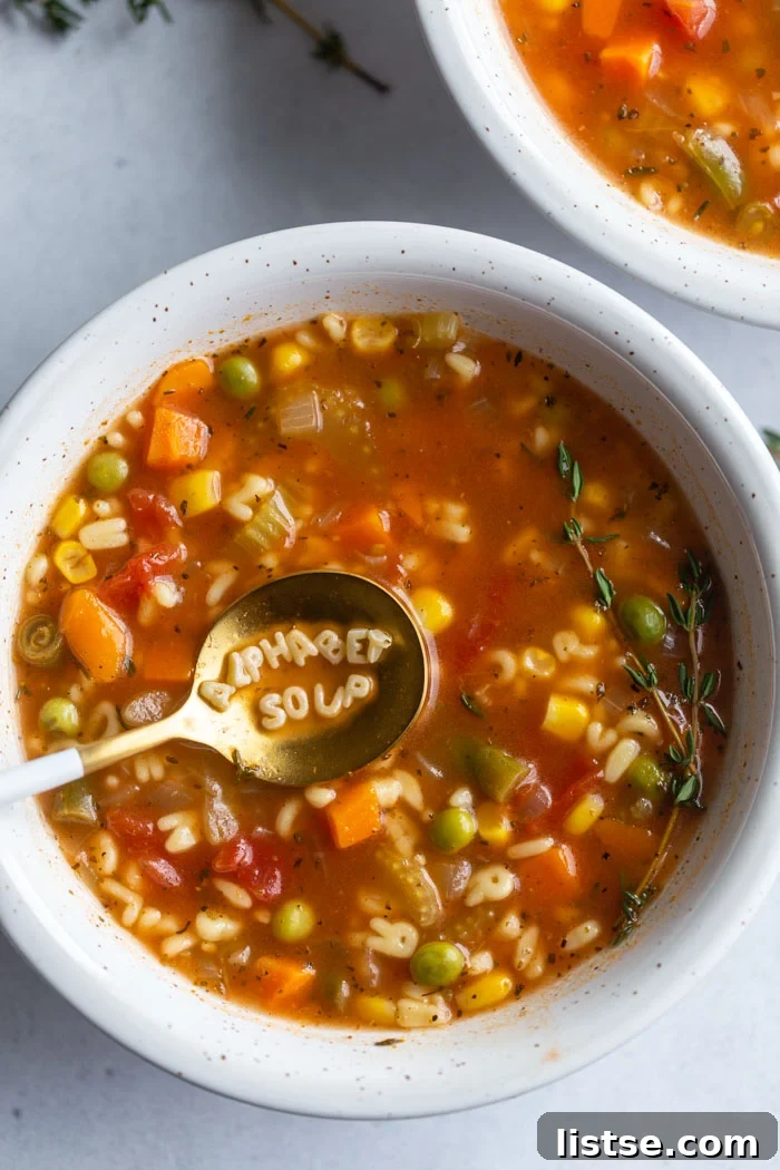 A-Z Delicious: Homemade Alphabet Soup 2 up close shot of a bowl of alphabet soup with the words "alphabet soup" spelled out on the spoon on the noodles