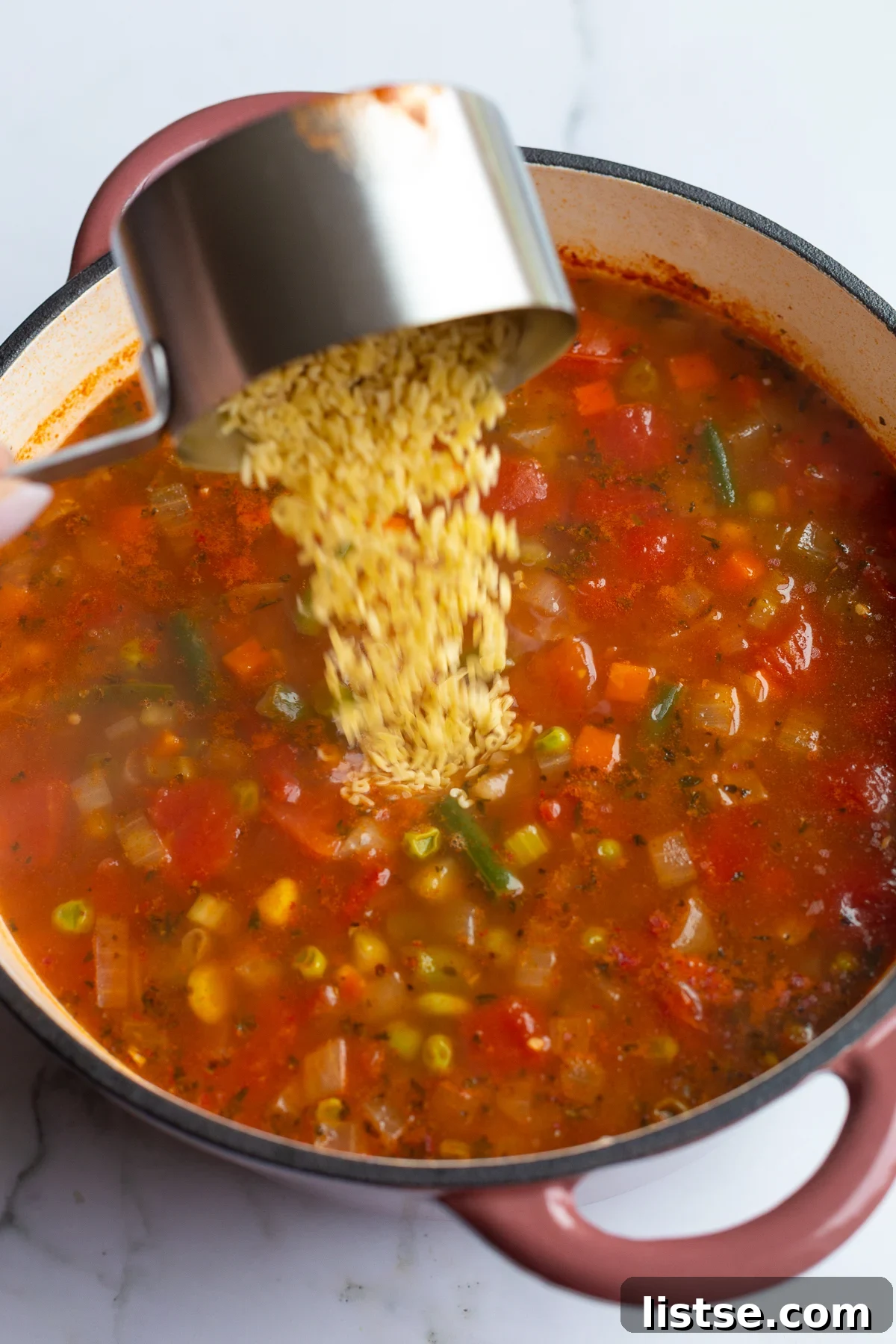 A-Z Delicious: Homemade Alphabet Soup 7 alphabet pasta being poured into a pot of soup