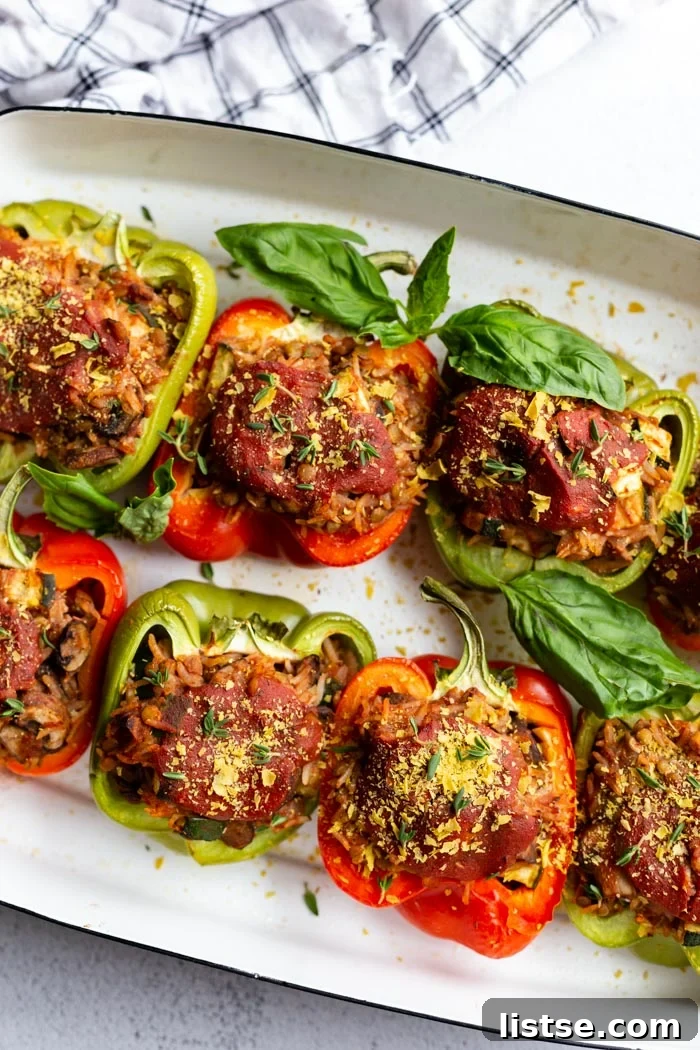 A close-up of a single vegan stuffed pepper, cut in half to show the delicious filling.