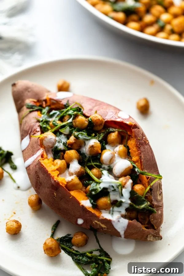 up close shot of a sweet potato stuffed with chickpeas and wilted arugula