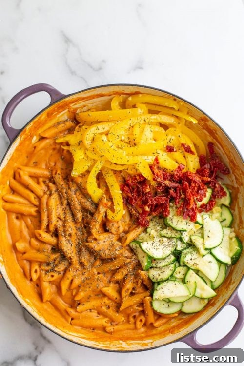 Creamy tomato one-pot pasta garnished with fresh basil