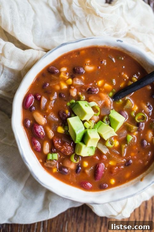 Loaded vegan chili topped with fresh avocado slices
